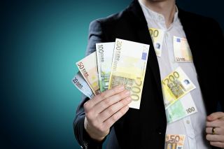 Foto: Mann mit Geldscheinen